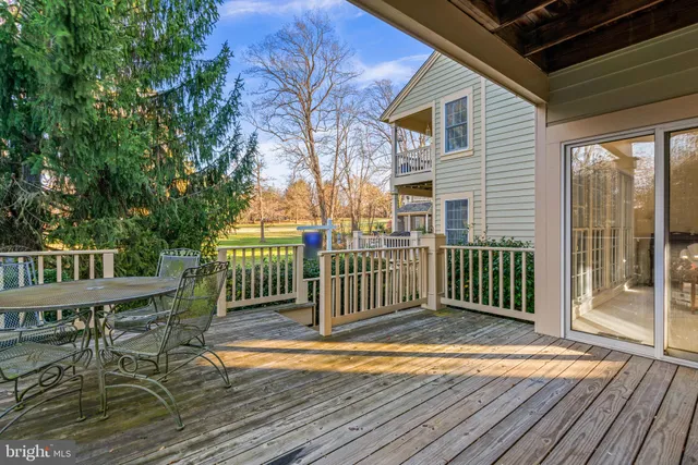 a view of a chair and table on the wooden deck