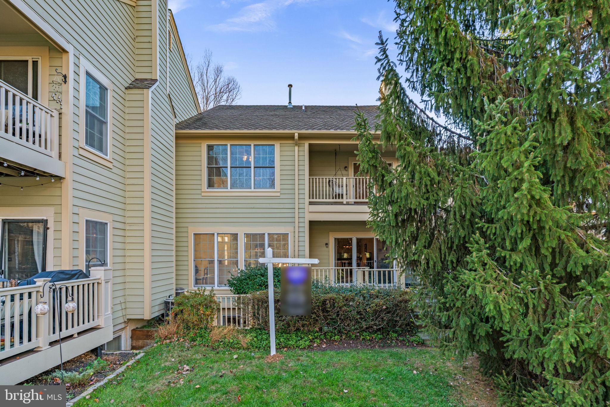 5161 Harpers Farm Road, Unit 27 Columbia, MD 21044 - Photo 43 of 55 a view of a house with brick walls and a yard with plants