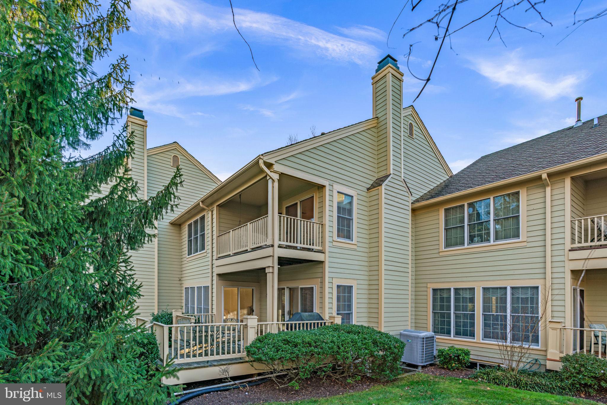 5161 Harpers Farm Road, Unit 27 Columbia, MD 21044 - Photo 44 of 55 a view of a brick house with a yard plants and large tree