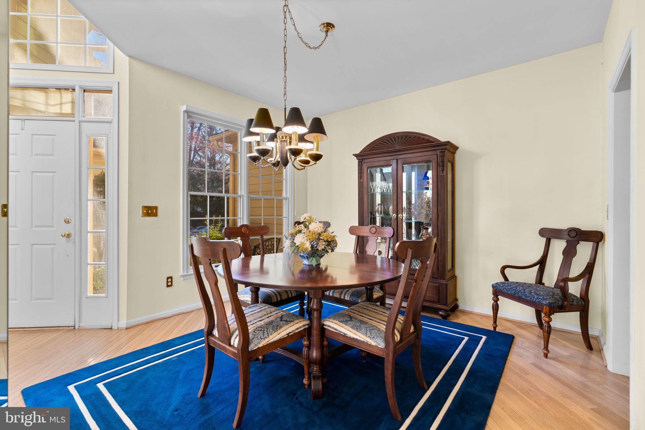 5161 Harpers Farm Road, Unit 27 Columbia, MD 21044 - Photo 9 of 55 a view of a dining room with furniture wooden floor and chandelier