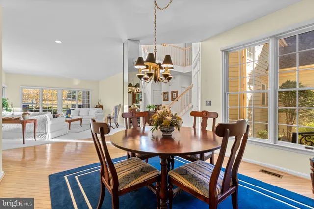 a dining room with furniture window and wooden floor