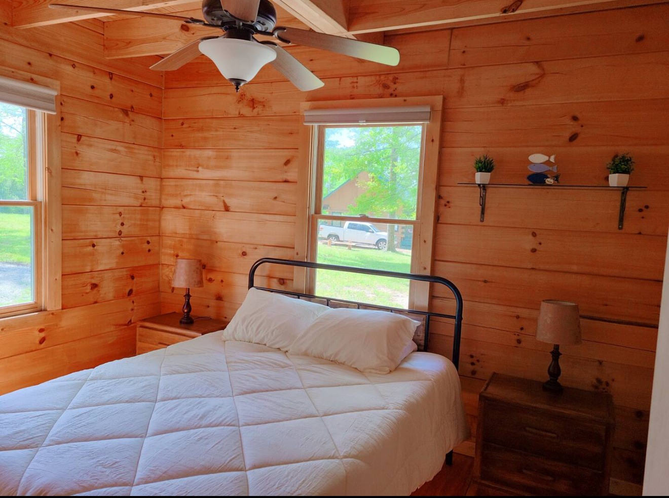 80 Tater Bug Lane Clifton, TN 38425 - Photo 13 of 25 a bedroom with a bed and a dresser next to a window