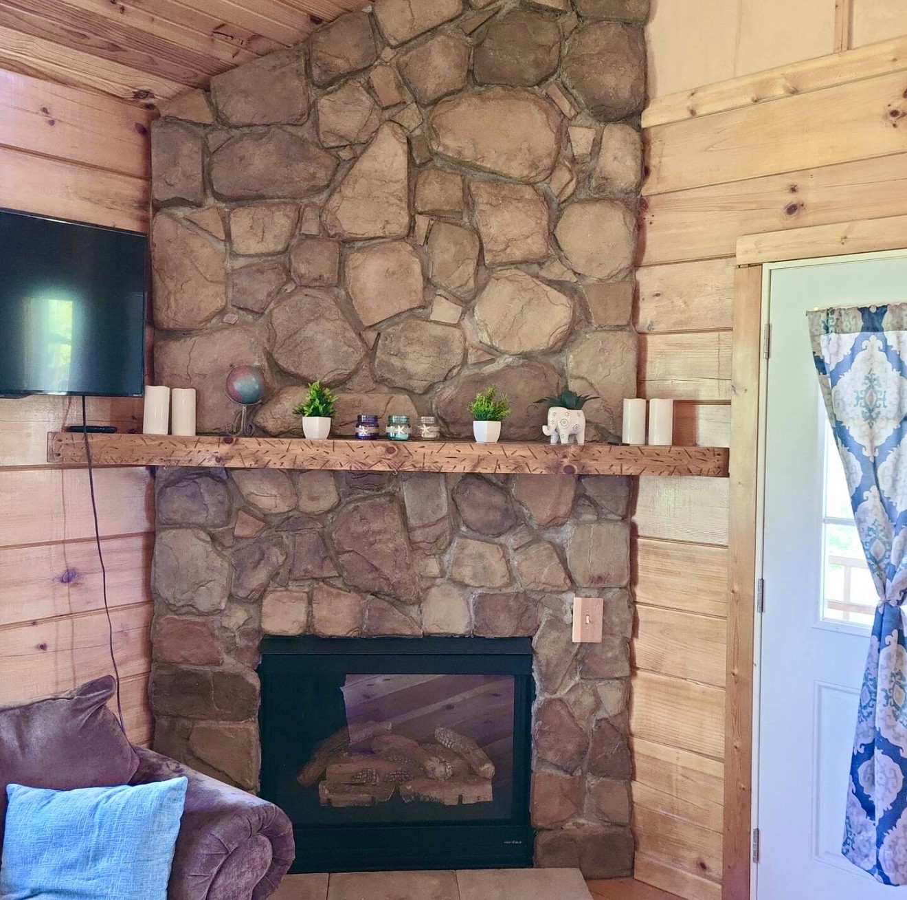 80 Tater Bug Lane Clifton, TN 38425 - Photo 7 of 25 a room with a fireplace and a flat screen tv