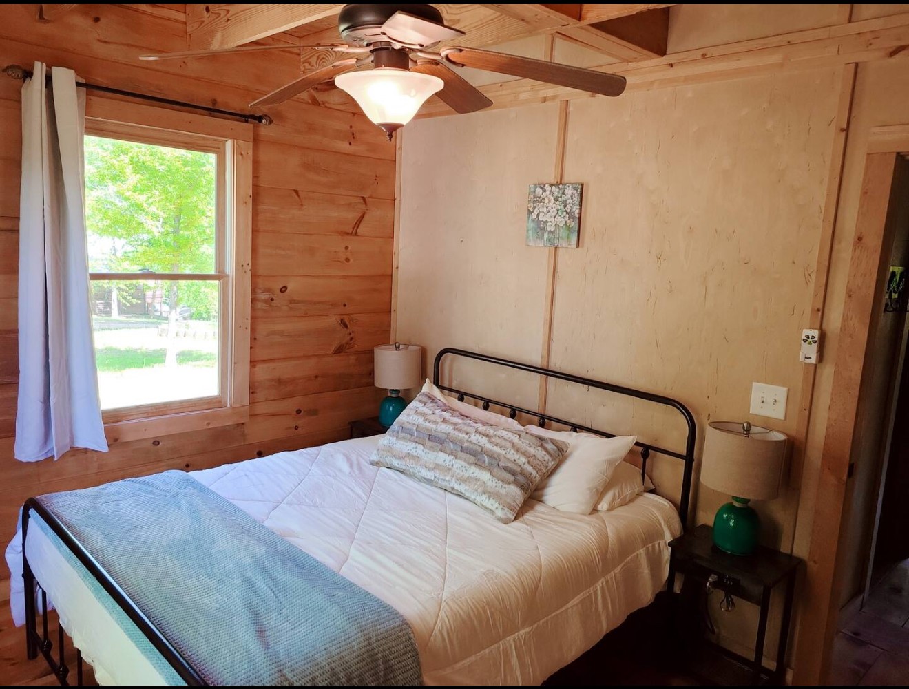 80 Tater Bug Lane Clifton, TN 38425 - Photo 8 of 25 a bedroom with a bed and a chandelier