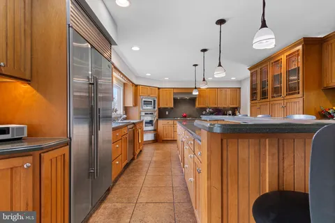 a kitchen with stainless steel appliances granite countertop wooden cabinets a sink and dishwasher