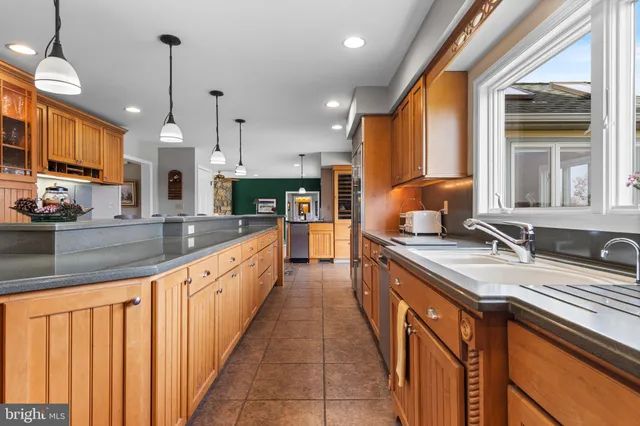 a open kitchen with stainless steel appliances granite countertop a refrigerator and a stove top oven