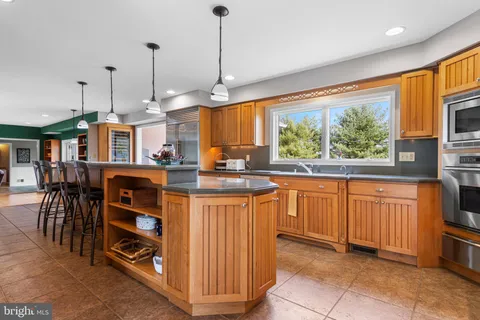 a kitchen with stainless steel appliances granite countertop a refrigerator and a stove top oven