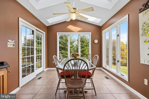 a view of a balcony with a floor to ceiling window and wooden fence