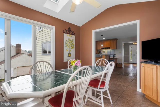 a dining room with furniture water potted plants and wooden floor