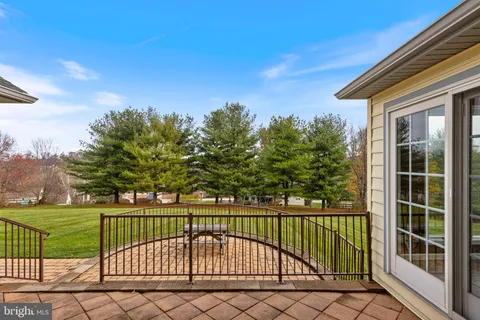 a dining room with furniture a chandelier and wooden floor