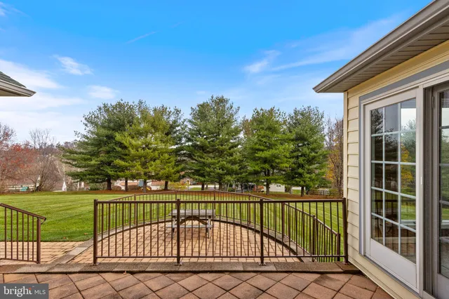 a dining room with furniture a chandelier and wooden floor