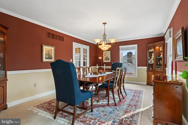 a view of a dining room with furniture and chandelier