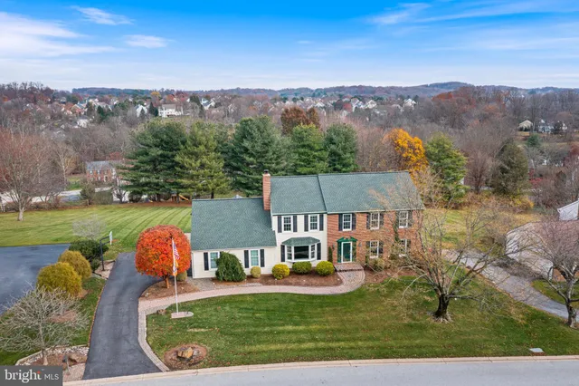 a view of a house with pool and a yard