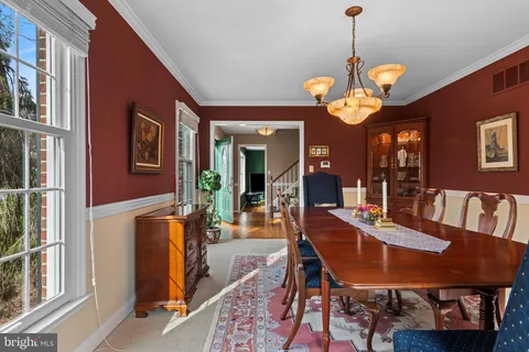 a view of a hallway with wooden floor and windows