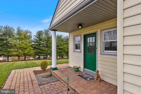 a living room with furniture and a kitchen