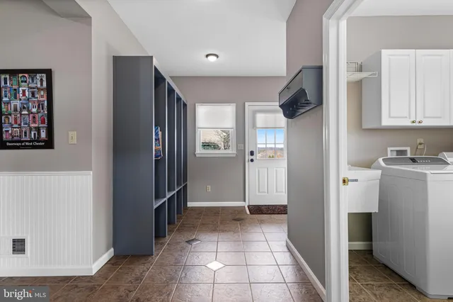 a bedroom with bed and a chandelier