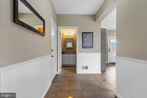 a spacious bathroom with a granite countertop sink a mirror and shower