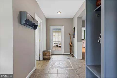 a bathroom with a granite countertop sink a mirror and shower