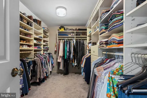 a front view of a house with a garden and yard