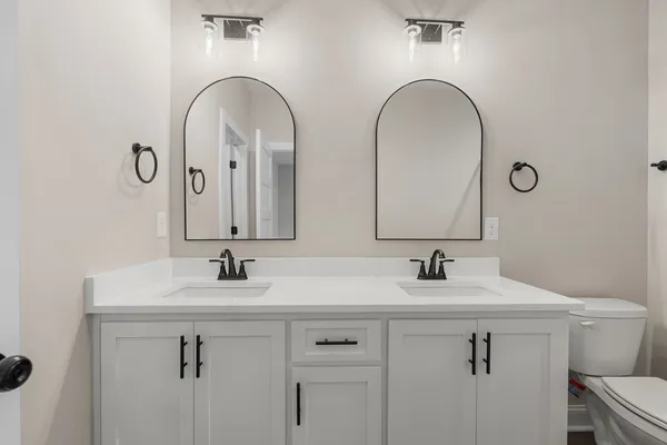 a bathroom with a shower a toilet and a sink