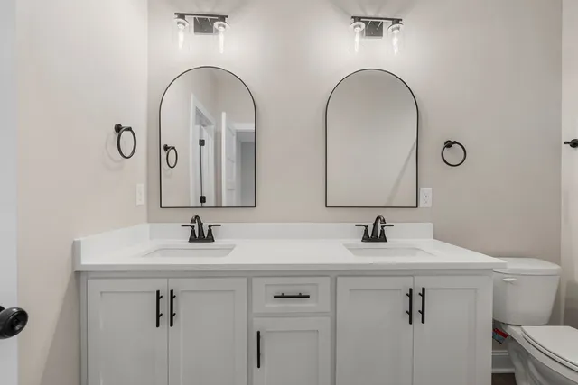 a bathroom with a shower a toilet and a sink