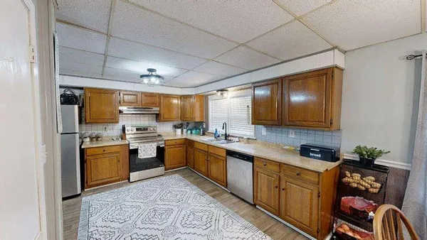 a kitchen with stainless steel appliances granite countertop a refrigerator and a sink