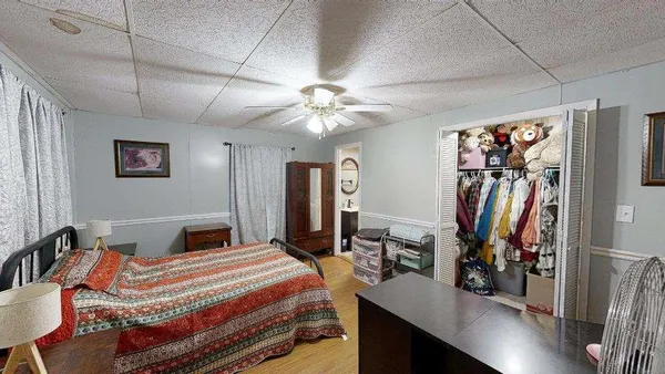 a bedroom with a bed and a chandelier