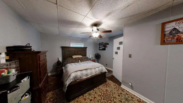 a bedroom with a bed and a television