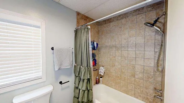 a bedroom with furniture and a window