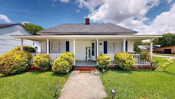 a front view of house with yard and swimming pool