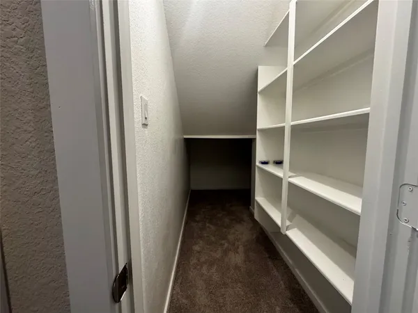 a view of an empty room with a ceiling fan
