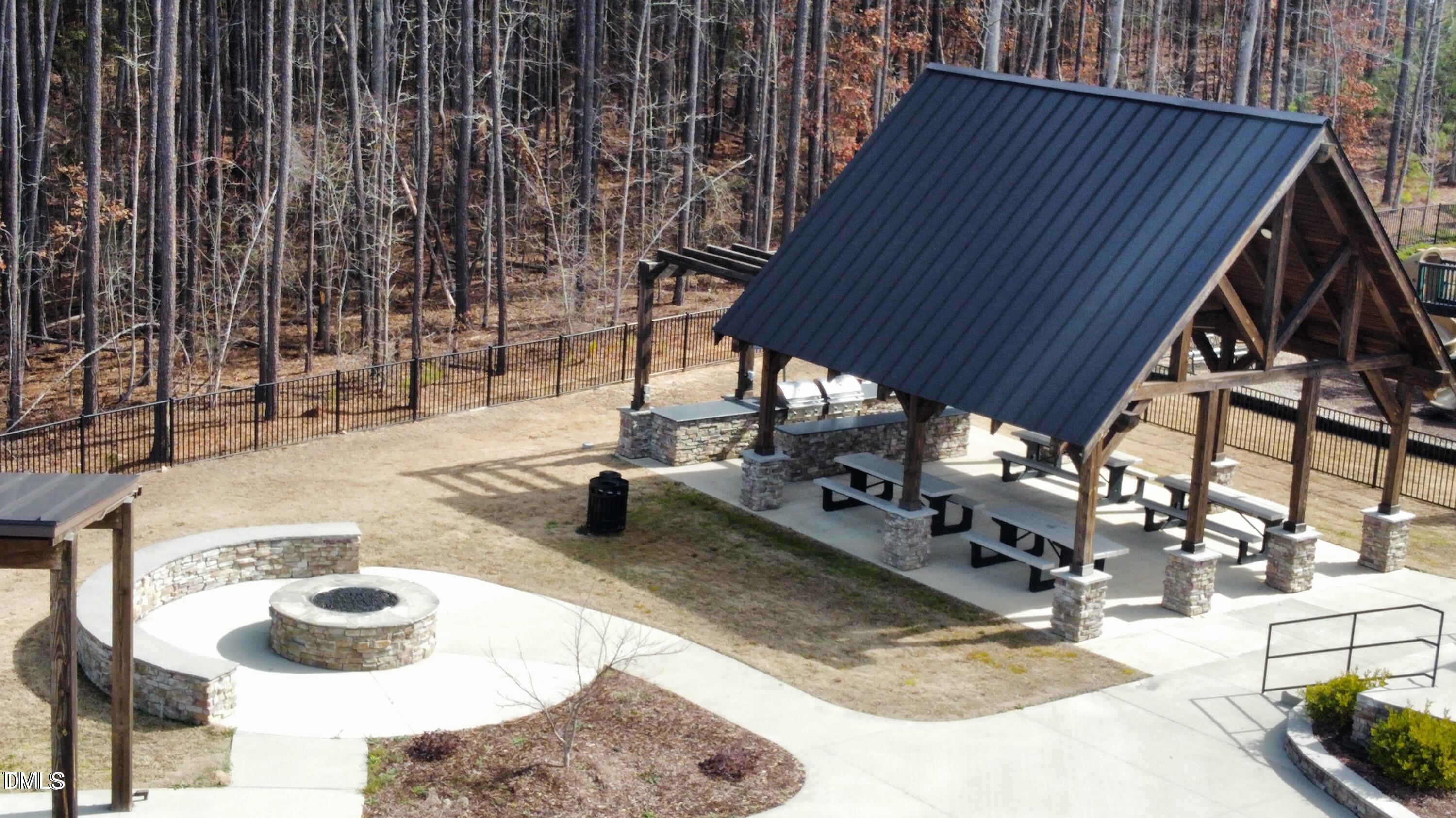 2555 Rambling Creek Road Apex, NC 27523 - Photo 22 of 23 a backyard of a house with table and chairs
