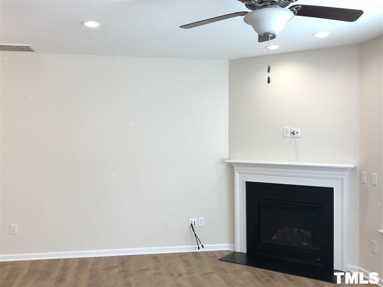 2555 Rambling Creek Road Apex, NC 27523 - Photo 6 of 23 a view of an empty room with a fireplace