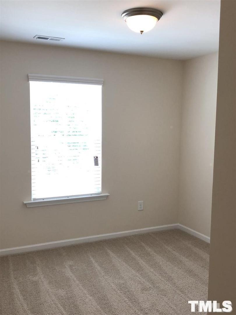 2555 Rambling Creek Road Apex, NC 27523 - Photo 9 of 23 an empty room with a window