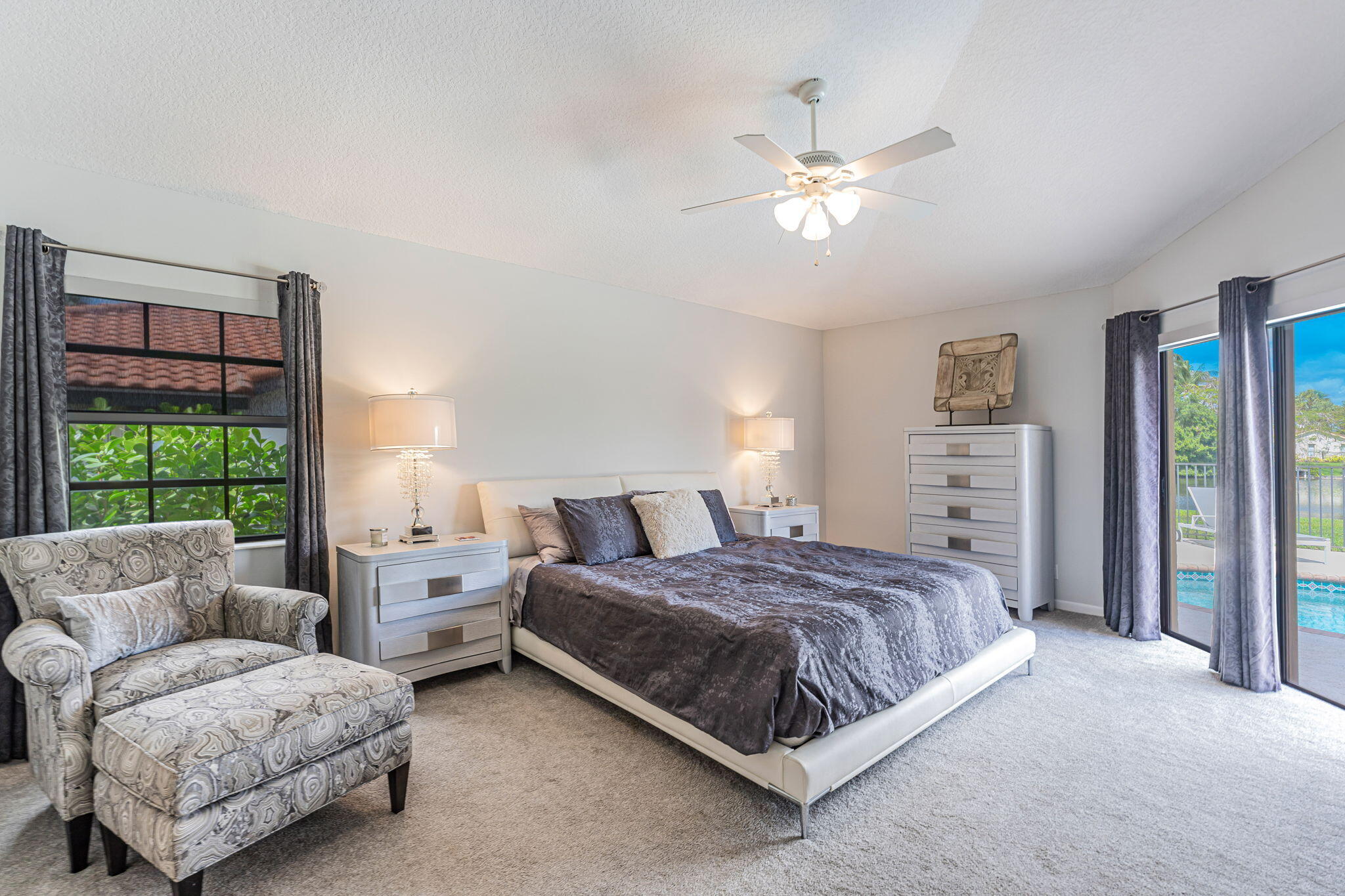 12715 Kingsway Road Wellington, FL 33414 - Photo 11 of 36 a spacious bedroom with a bed and ceiling fan
