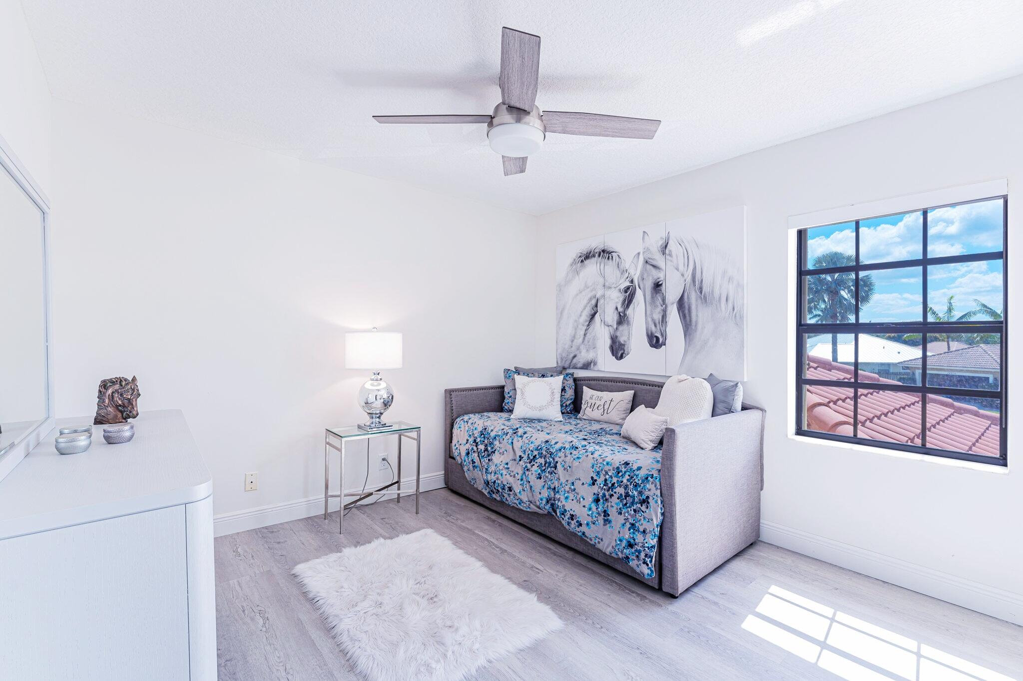 12715 Kingsway Road Wellington, FL 33414 - Photo 13 of 36 a living room with furniture and a window
