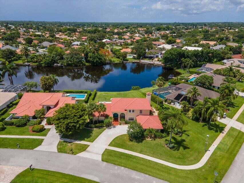 12715 Kingsway Road Wellington, FL 33414 - Photo 17 of 36 an aerial view of a house with a garden and lake view
