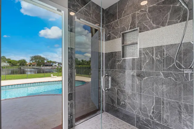 a view of a bathroom with a tub and window