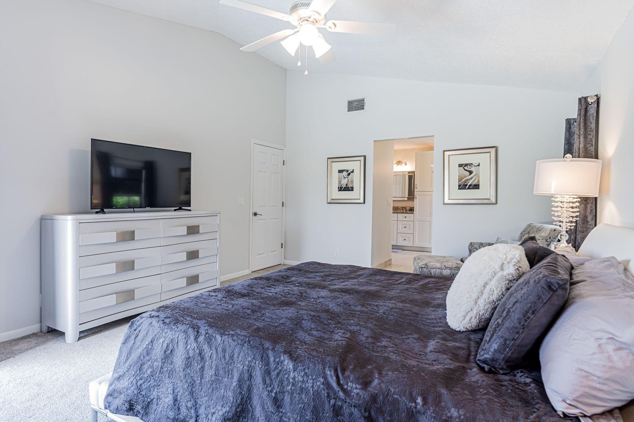 12715 Kingsway Road Wellington, FL 33414 - Photo 23 of 36 a bedroom with a bed and a flat screen tv