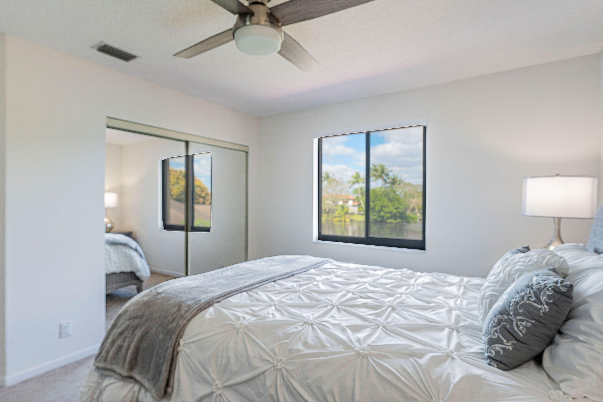 12715 Kingsway Road Wellington, FL 33414 - Photo 24 of 36 a bedroom with a bed and a window