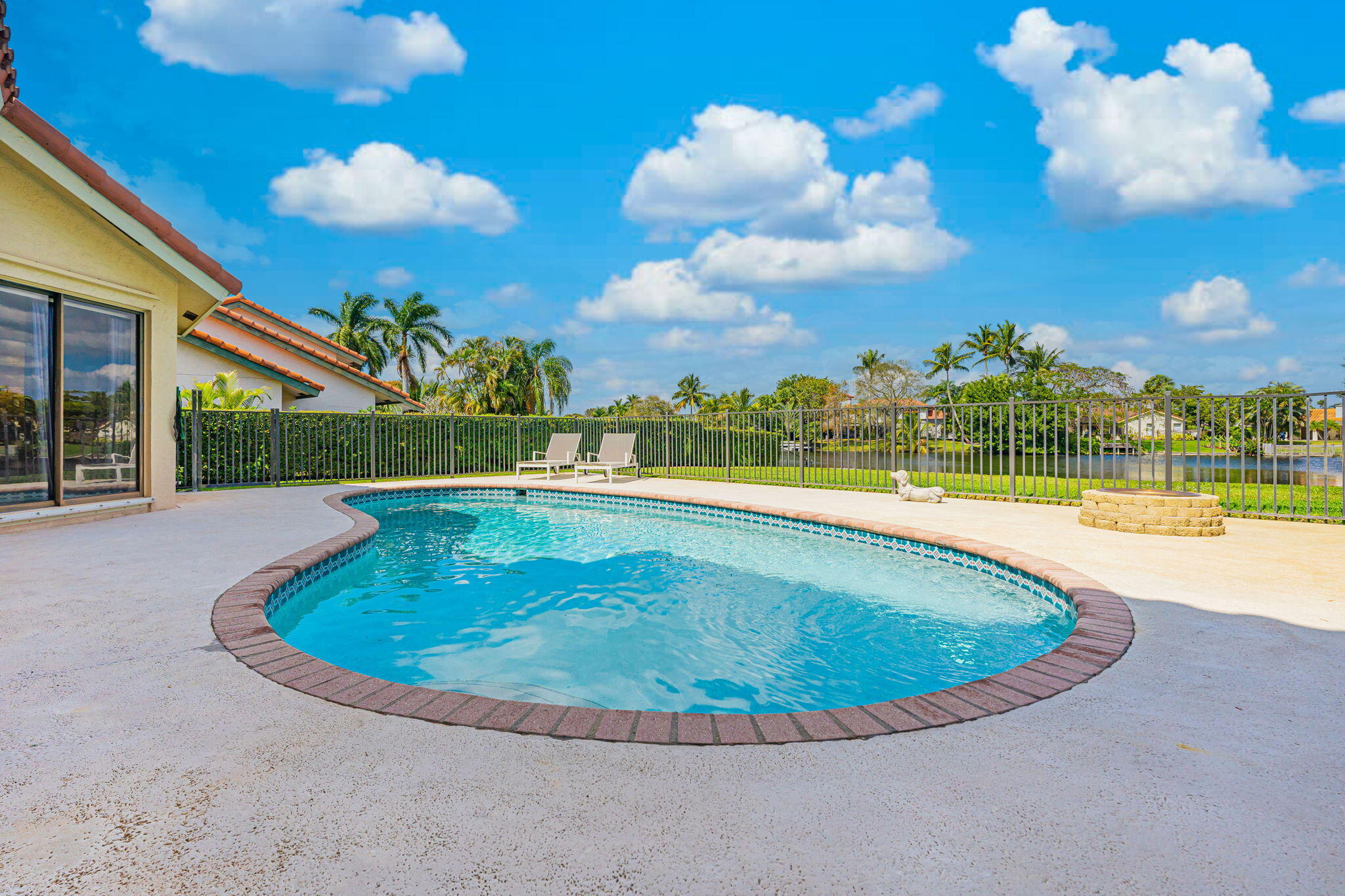 12715 Kingsway Road Wellington, FL 33414 - Photo 28 of 36 a view of a swimming pool with a yard