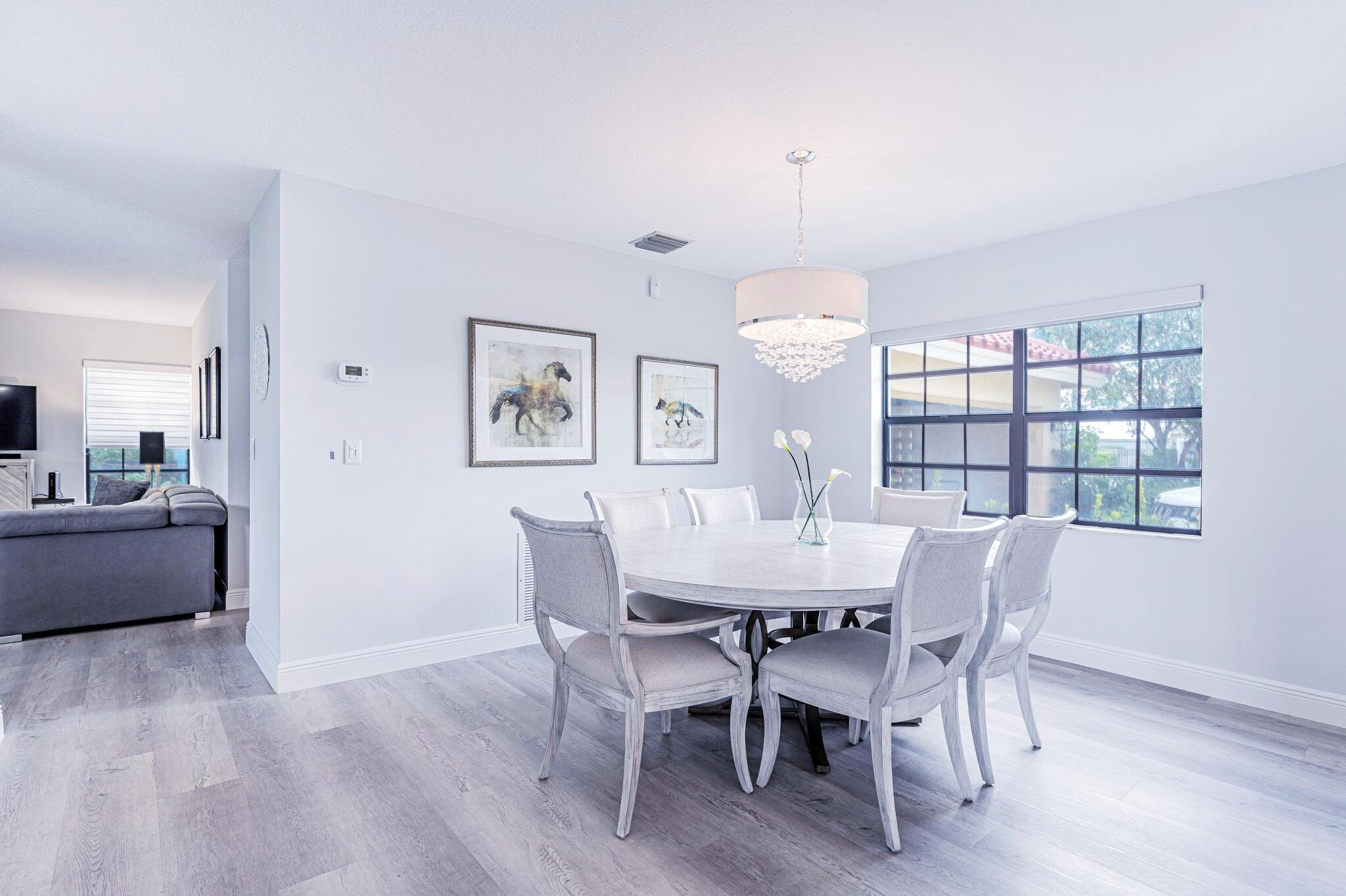 12715 Kingsway Road Wellington, FL 33414 - Photo 7 of 36 a view of a dining room with furniture window and wooden floor