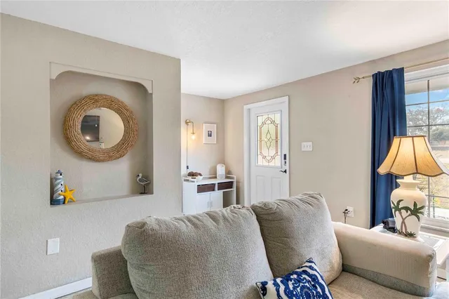 a kitchen with stainless steel appliances kitchen island granite countertop a refrigerator a sink a stove and white cabinets