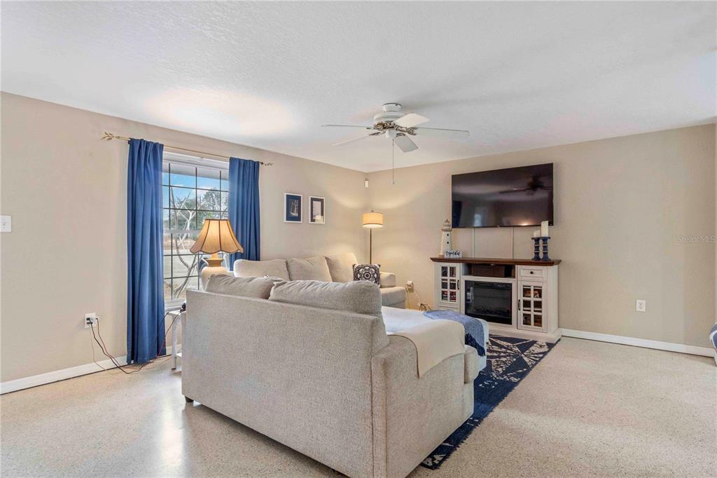 333 Hile Lane Punta Gorda, FL 33982 - Photo 15 of 72 a living room with furniture a fireplace and a flat screen tv