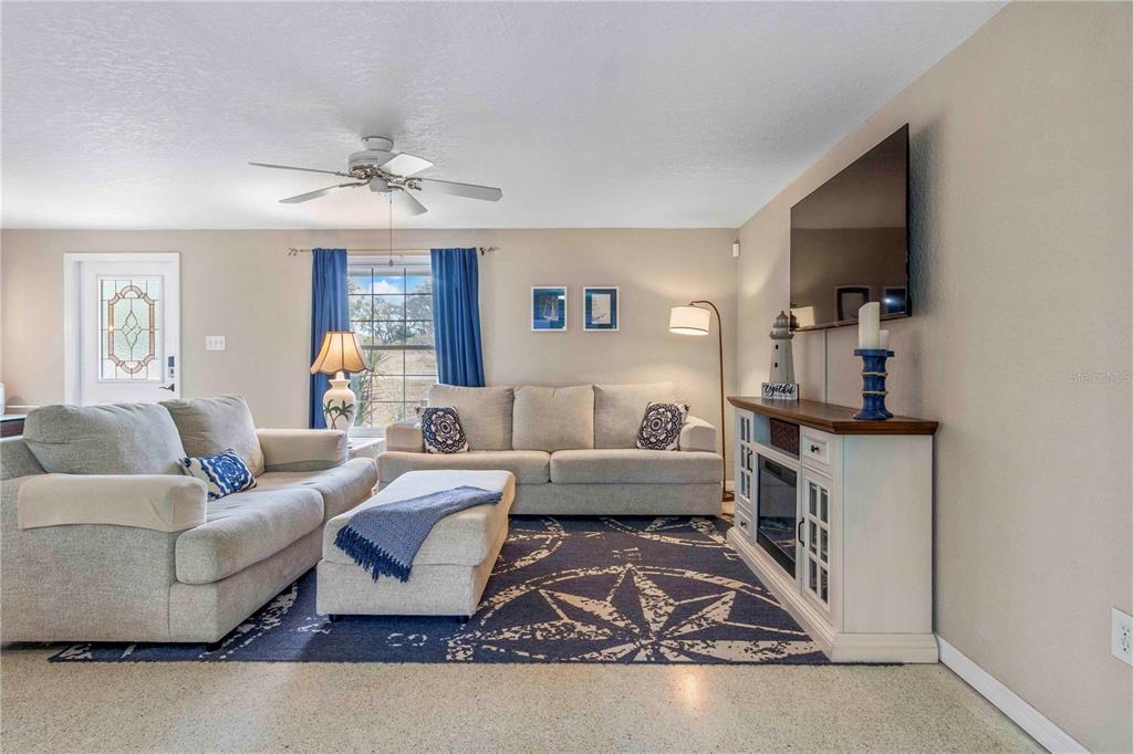 333 Hile Lane Punta Gorda, FL 33982 - Photo 17 of 72 a living room with furniture a rug and a chandelier