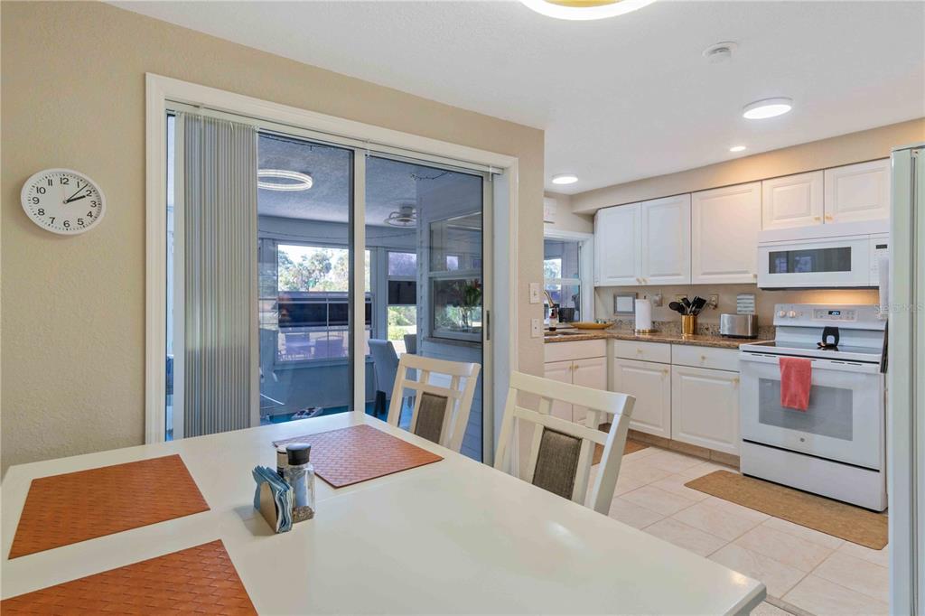 333 Hile Lane Punta Gorda, FL 33982 - Photo 23 of 72 a kitchen with stainless steel appliances kitchen island granite countertop a refrigerator a sink a stove and white cabinets