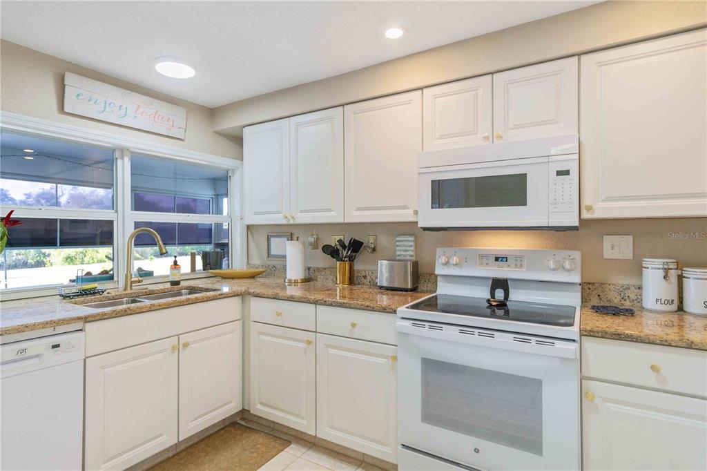 333 Hile Lane Punta Gorda, FL 33982 - Photo 24 of 72 a kitchen with white cabinets and white appliances