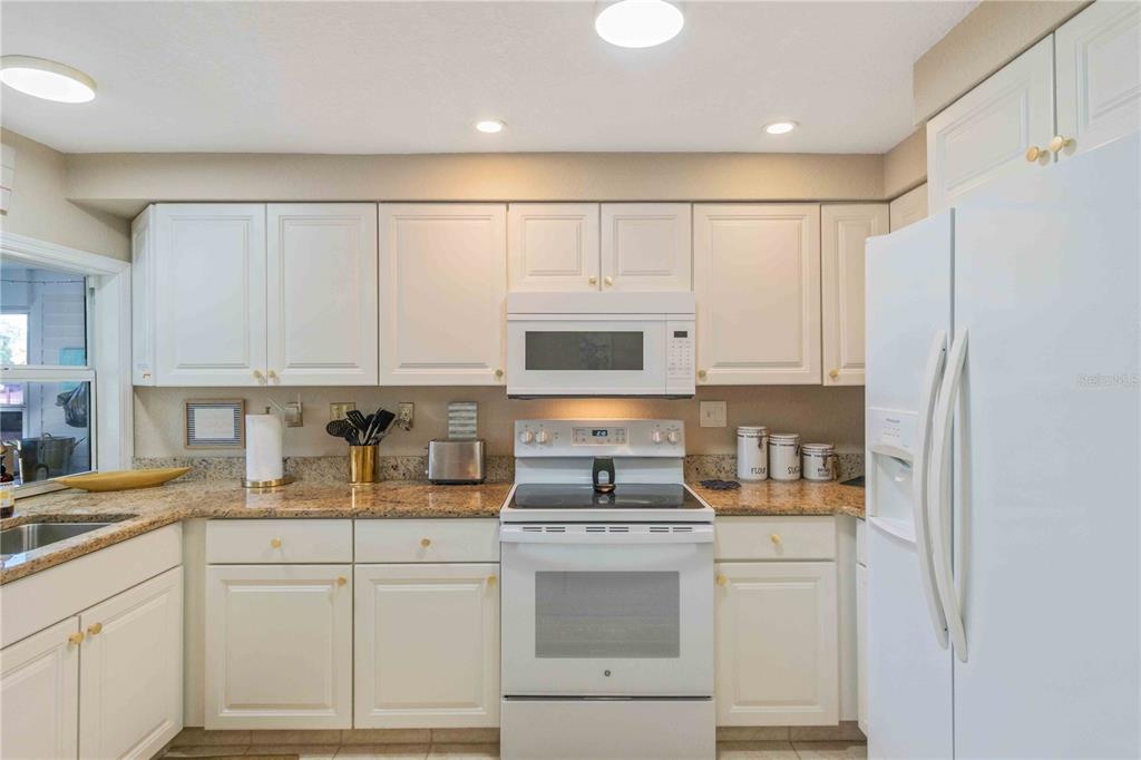 333 Hile Lane Punta Gorda, FL 33982 - Photo 25 of 72 a kitchen with stainless steel appliances granite countertop a refrigerator sink and white cabinets