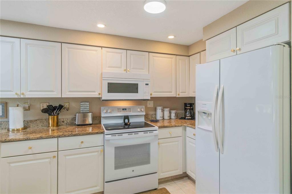 333 Hile Lane Punta Gorda, FL 33982 - Photo 26 of 72 a kitchen with stainless steel appliances white cabinets and a refrigerator