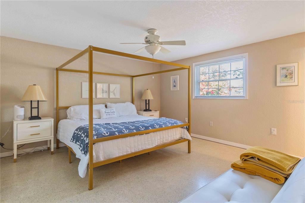 333 Hile Lane Punta Gorda, FL 33982 - Photo 32 of 72 a bedroom with a bed and a chandelier